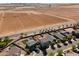 An aerial view highlights a community with a house that backs up to farmland at 17043 N Avelino Dr, Maricopa, AZ 85138
