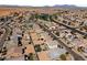This aerial view shows a residential area with houses, backyards, and a community park at 17043 N Avelino Dr, Maricopa, AZ 85138