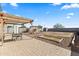 Enjoy the spacious backyard featuring a pergola, seating area, and ample space for gardening at 17043 N Avelino Dr, Maricopa, AZ 85138