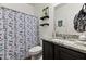 Bathroom featuring a granite-topped vanity and a shower with a stylish blue-patterned curtain at 17043 N Avelino Dr, Maricopa, AZ 85138