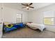 Bedroom features 2 twin beds, neutral carpet, and dual windows with bright light at 17043 N Avelino Dr, Maricopa, AZ 85138