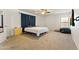 Bedroom featuring neutral walls, carpeting, large bed, and natural wood dresser, offering comfort and style at 17043 N Avelino Dr, Maricopa, AZ 85138