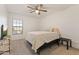 Bright bedroom featuring neutral carpet, a ceiling fan, and a queen sized bed in a staged home at 17043 N Avelino Dr, Maricopa, AZ 85138