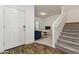 Bright entryway with staircase, stylish floors, and a doorway to what looks like an office at 17043 N Avelino Dr, Maricopa, AZ 85138