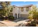 Daytime shot of this two-story home featuring a desert-style landscape and a two car garage at 17043 N Avelino Dr, Maricopa, AZ 85138