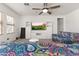 Stylish living room showcasing a TV on a media center and comfortable, paisley patterned couches at 17043 N Avelino Dr, Maricopa, AZ 85138