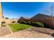 Private backyard featuring a well-maintained lawn, mature shrubs, and a paved patio area at 1739 E Elegante Dr, Casa Grande, AZ 85122