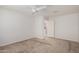 Carpeted bedroom with a ceiling fan and an open doorway at 1739 E Elegante Dr, Casa Grande, AZ 85122