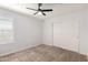 Bedroom with a ceiling fan, sliding closet doors, and window with shutters at 1739 E Elegante Dr, Casa Grande, AZ 85122