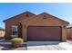 Exterior front of a house with a two car garage and desert landscaping at 1739 E Elegante Dr, Casa Grande, AZ 85122