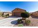Exterior of a house with a two car garage and desert landscaping at 1739 E Elegante Dr, Casa Grande, AZ 85122