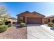 Charming single-story home featuring a two-car garage, desert landscaping, and a neutral-toned exterior at 1739 E Elegante Dr, Casa Grande, AZ 85122
