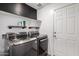 Laundry room with front load washer and dryer and floating shelves at 1739 E Elegante Dr, Casa Grande, AZ 85122