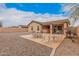 The backyard features desert landscaping, a built-in grill, and a covered patio at 1775 E Sycamore Rd, Casa Grande, AZ 85122