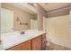 Bathroom with wood vanity, large mirror, and shower-tub combination at 1775 E Sycamore Rd, Casa Grande, AZ 85122
