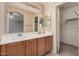 Bathroom features a double sink vanity with a large mirror and a door to a separate toilet and shower area at 1775 E Sycamore Rd, Casa Grande, AZ 85122