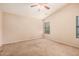 This bedroom is a blank canvas that includes a ceiling fan and plush carpet at 1775 E Sycamore Rd, Casa Grande, AZ 85122
