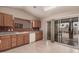 Kitchen showcasing light wood cabinetry, white appliances, and a sliding glass door leading to the patio at 1775 E Sycamore Rd, Casa Grande, AZ 85122