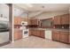 Traditional style kitchen features light wood cabinets, white appliances and unique backsplash at 1775 E Sycamore Rd, Casa Grande, AZ 85122
