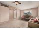 Open living room featuring neutral carpet, large windows and a view of the front door at 1775 E Sycamore Rd, Casa Grande, AZ 85122