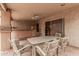Covered patio with stucco walls, a ceiling fan, and outdoor seating around a table at 1775 E Sycamore Rd, Casa Grande, AZ 85122