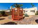 Backyard showcasing a red gazebo, desert landscaping, and rock ground cover, offering a unique outdoor space at 1839 E Vinedo Ln, Tempe, AZ 85284