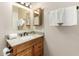 Bathroom featuring a granite countertop, wood cabinets, and framed mirror at 1839 E Vinedo Ln, Tempe, AZ 85284