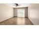 Bright, empty bedroom with tile floors, ceiling fan, and sliding glass doors at 1839 E Vinedo Ln, Tempe, AZ 85284