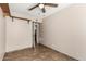 Spacious empty bedroom featuring tile floors, ceiling fan and shelf with bi-fold doors at 1839 E Vinedo Ln, Tempe, AZ 85284