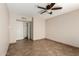 Neutral bedroom with tile floor, ceiling fan and closet with bi-fold doors at 1839 E Vinedo Ln, Tempe, AZ 85284