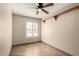 Empty bedroom featuring tile floors, ceiling fan, window with shutters and display shelving at 1839 E Vinedo Ln, Tempe, AZ 85284