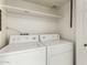 Bright laundry room featuring a white washer and dryer set and a convenient storage shelf above at 1839 E Vinedo Ln, Tempe, AZ 85284