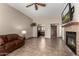Spacious living room with fireplace, tile floors, ceiling fan, and open to the kitchen at 1839 E Vinedo Ln, Tempe, AZ 85284