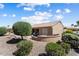 Backyard with landscaped patio and lawn for entertaining with Arizona room with tile roof at 19722 N Regents Park Dr, Surprise, AZ 85387