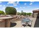 Backyard patio with glass table and seating area for outdoor dining and relaxation at 19722 N Regents Park Dr, Surprise, AZ 85387