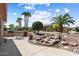 Outdoor living with built-in BBQ, rock feature, and desert landscaping for relaxing and entertaining at 19722 N Regents Park Dr, Surprise, AZ 85387