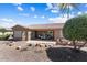 Spacious patio with dining set and landscaping in rear of home perfect for entertaining or relaxing at 19722 N Regents Park Dr, Surprise, AZ 85387