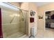 Bathroom featuring tiled shower and tile flooring, plus adjacent closet with clothing and storage at 19722 N Regents Park Dr, Surprise, AZ 85387