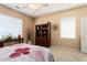 Neutral bedroom with bookcase and two windows at 19722 N Regents Park Dr, Surprise, AZ 85387