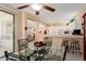 Inviting dining area with a glass table and chairs, flowing into an open-concept kitchen at 19722 N Regents Park Dr, Surprise, AZ 85387