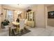 Elegant dining room featuring tile floors, natural lighting, and a chandelier for a refined dining experience at 19722 N Regents Park Dr, Surprise, AZ 85387