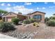 Charming single-story home with a well-maintained desert landscape and a classic Southwestern design at 19722 N Regents Park Dr, Surprise, AZ 85387