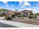 Front yard features desert landscaping, mature bushes, and a rock water feature at 19722 N Regents Park Dr, Surprise, AZ 85387