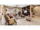 Bright living room with custom built-ins, tile flooring, and natural lighting, perfect for relaxation at 19722 N Regents Park Dr, Surprise, AZ 85387