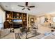 Comfortable living room featuring a built-in entertainment center, tile floors, and neutral decor for a cozy atmosphere at 19722 N Regents Park Dr, Surprise, AZ 85387