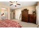 Comfortable main bedroom with a ceiling fan, ensuite bathroom, and lots of storage at 19722 N Regents Park Dr, Surprise, AZ 85387