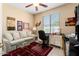 Cozy office featuring a sofa, desk, and large window at 19722 N Regents Park Dr, Surprise, AZ 85387