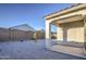 The backyard offers gravel, a block wall, and patio at 20162 W Buchanan St, Buckeye, AZ 85326
