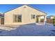 The home's backyard features a simple design, with a covered patio extending from the house, complemented by gravel landscaping at 20162 W Buchanan St, Buckeye, AZ 85326