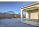 Desert landscaped backyard with a covered patio and a view of neighboring homes at 20162 W Buchanan St, Buckeye, AZ 85326